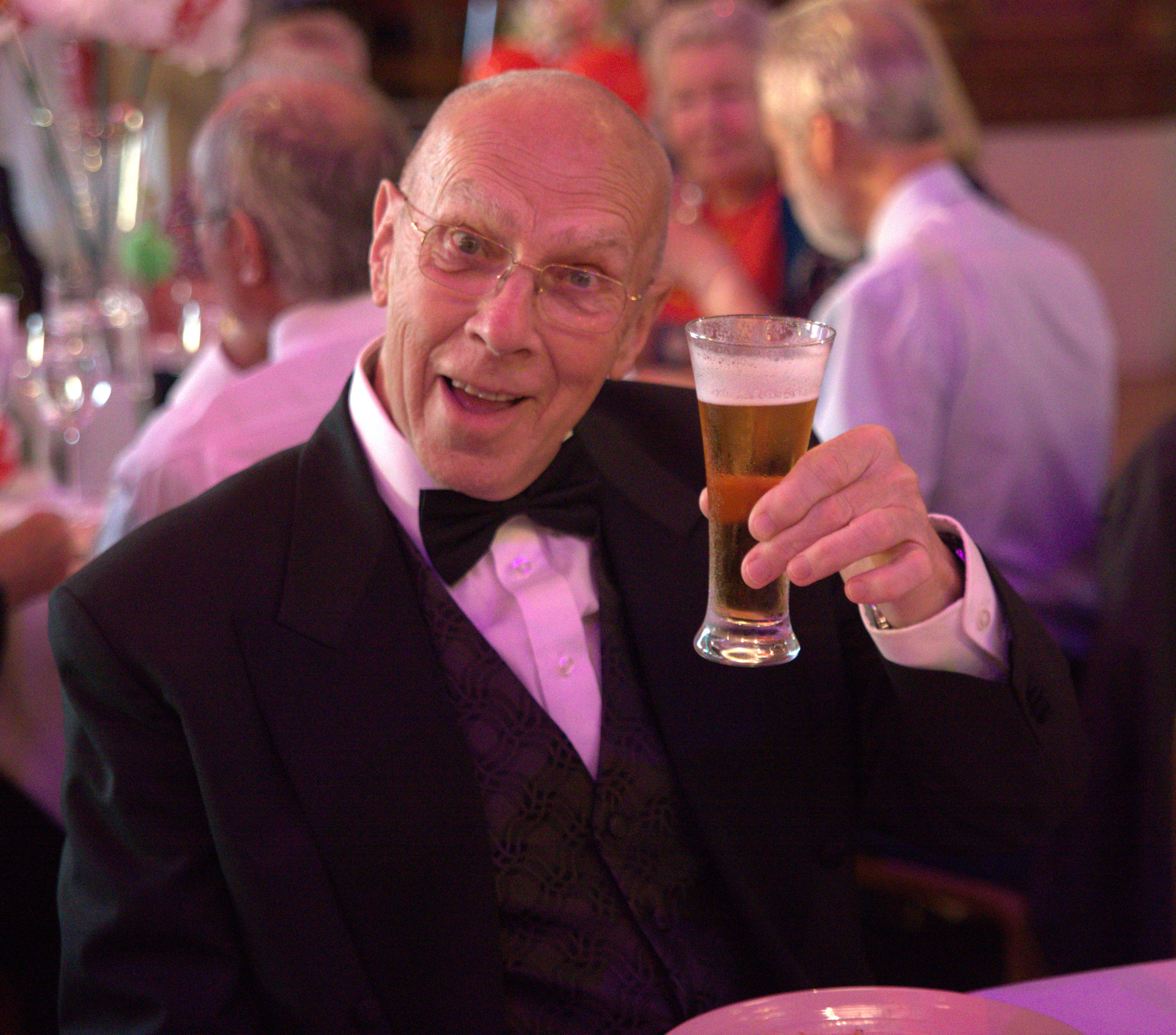 Guest raising a glass at a formal corporate event